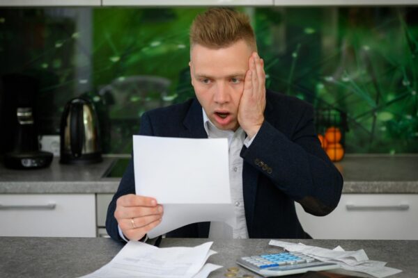 Man in shock regarding his monthly bills and finances