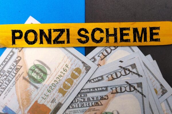 Top view banknotes and colored ice cream stick with text PONZI SCHEME on colored background