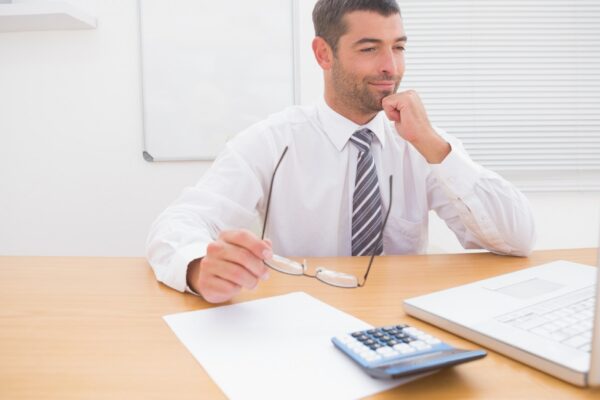 Businessman looking his laptop at his desk
