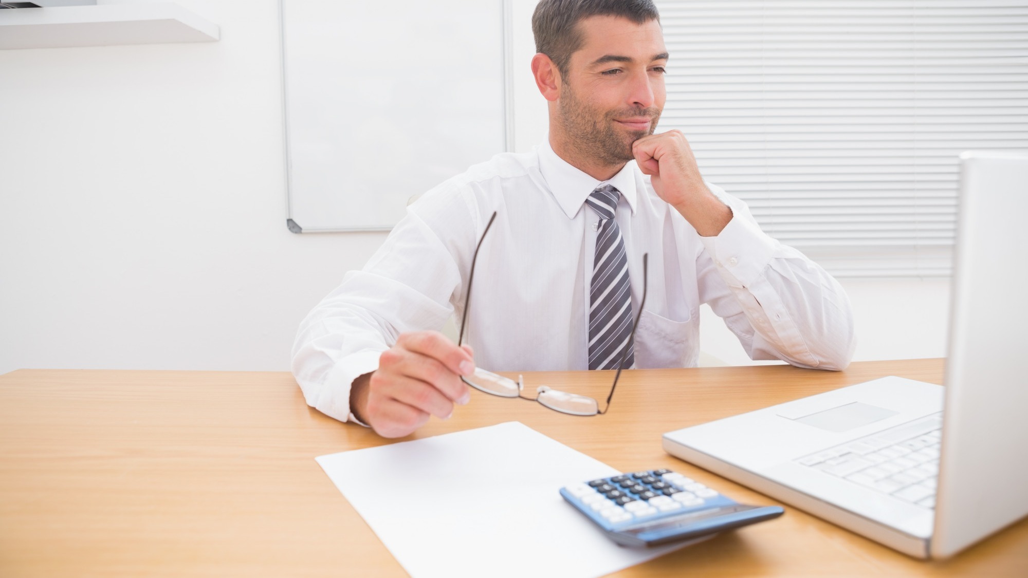 Businessman looking his laptop at his desk