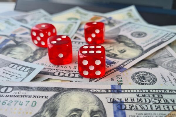 Dice and dollar banknotes on laptop keyboard Online casino and online gambling c