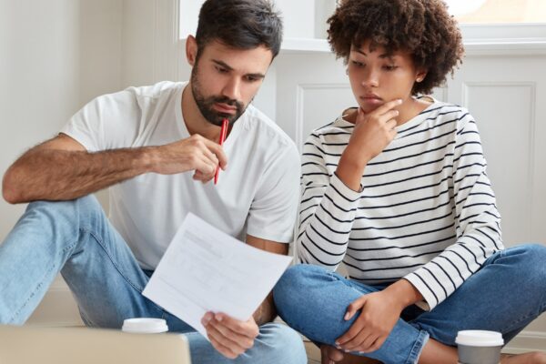 Indoor shot of serious mixed race woman and man study private arrangement, work from home