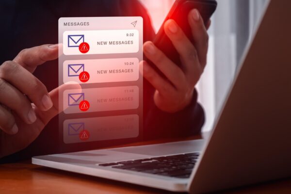 SMS scam or fake text message phishing concept System hacked warning alert email hack scam malware spreading virus on messages alert virtual on mobile smart phone screen in person people hand