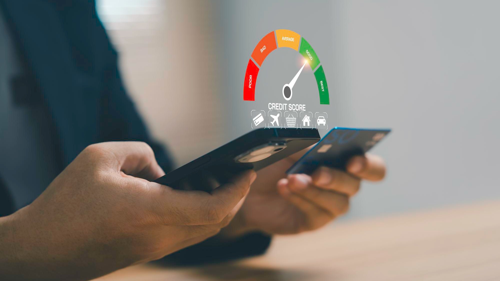 Businessman holding credit card and smartphone with credit score gauge showing good rating for financial health personal finance credit analysis responsible spending and banking technology concept