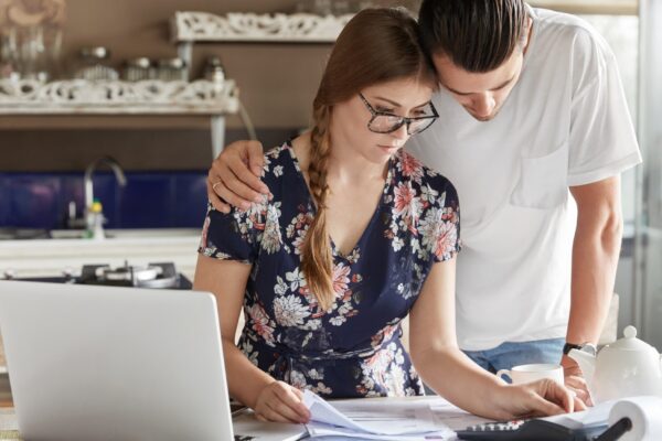 Couple managing budget together in kitchen