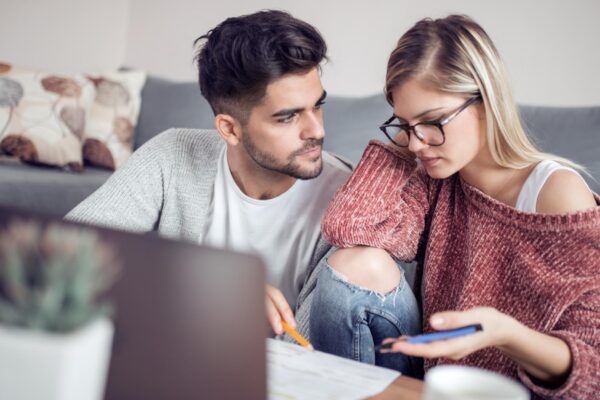 Young couple calculating their domestic bills at home