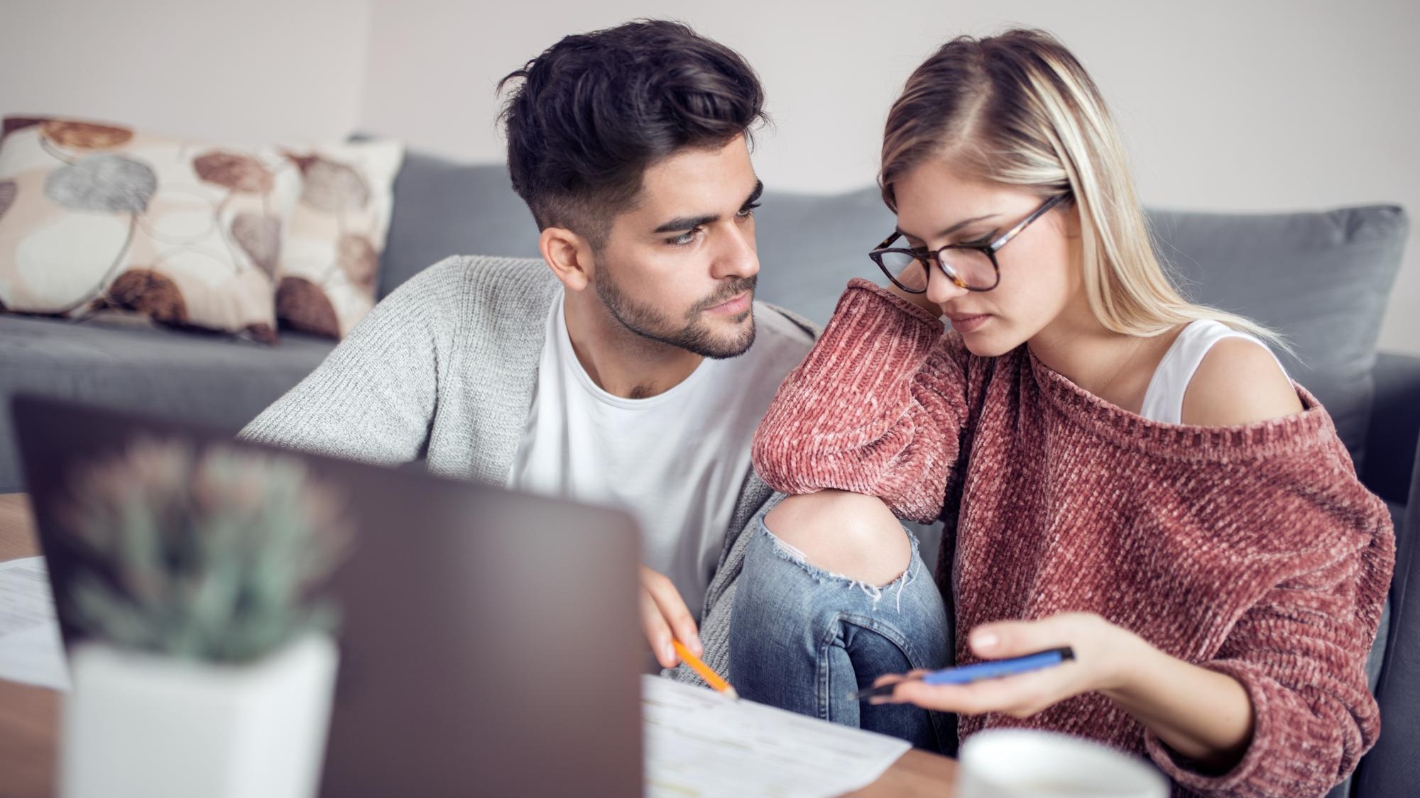 Young couple calculating their domestic bills at home