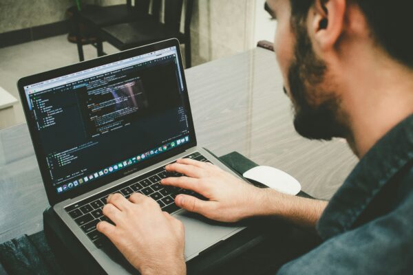 man programming using laptop
