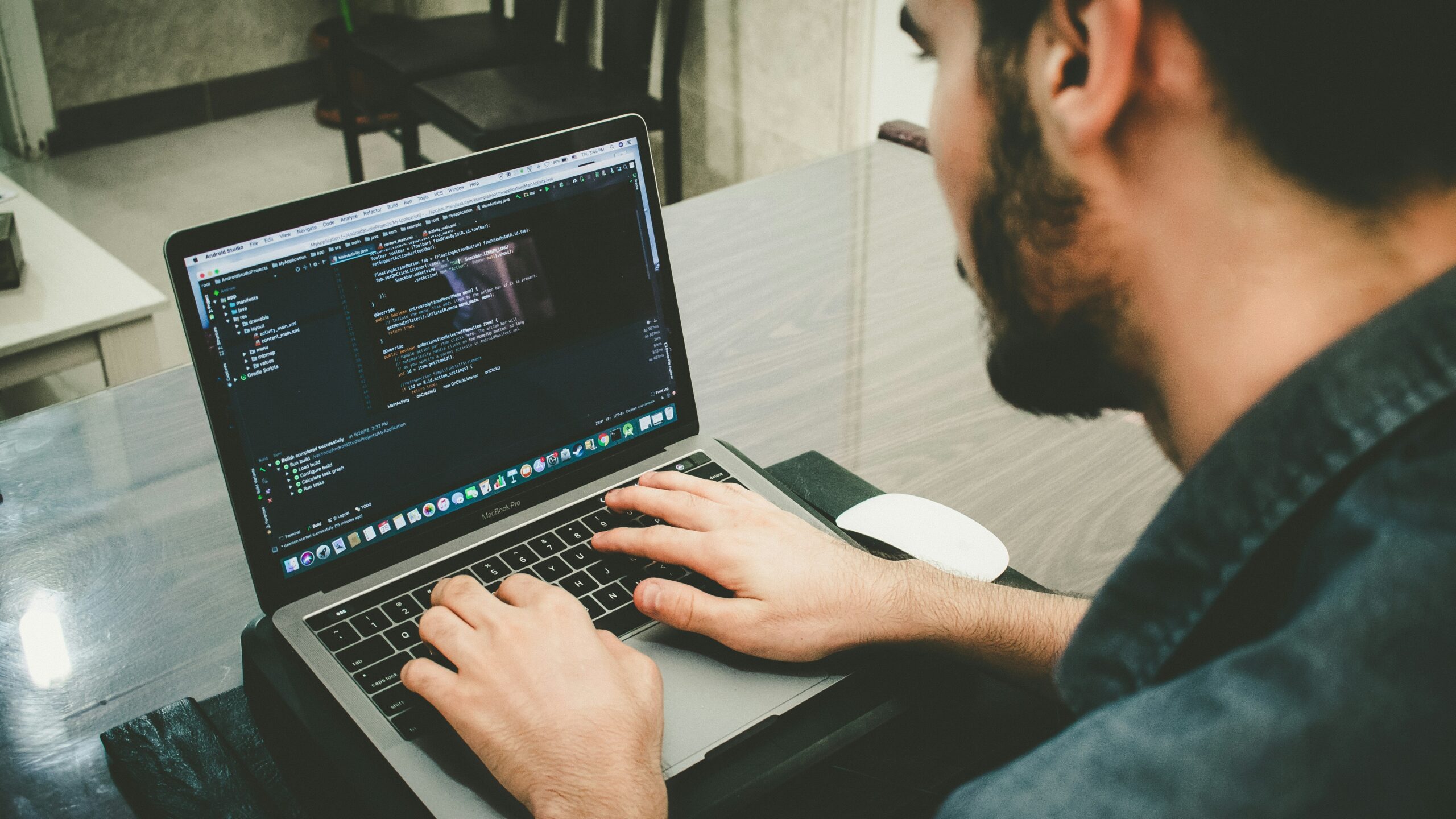 man programming using laptop