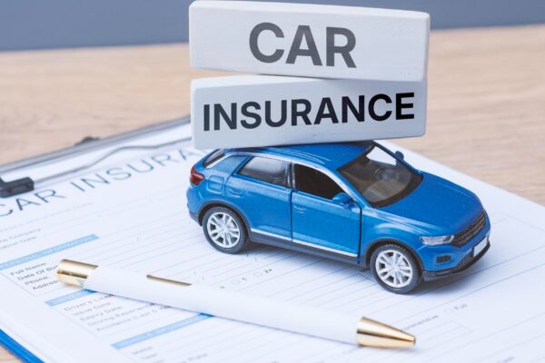 Toy car insurance text blocks on a insurance application form and clipboard Auto protection vehicle