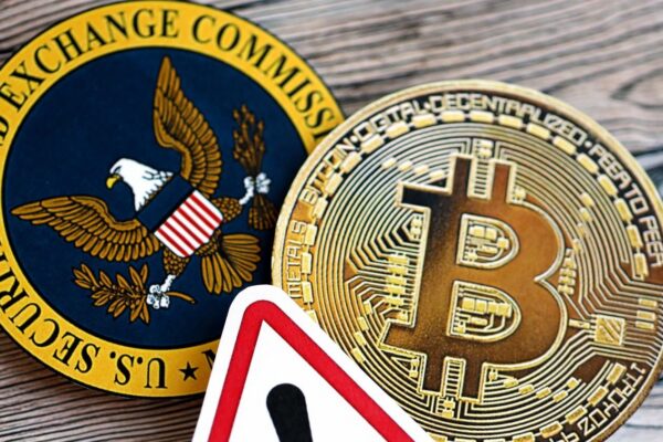 Bitcoin BTC coin and red paper attention sign with Securities and Exchange Commission on wooden background
