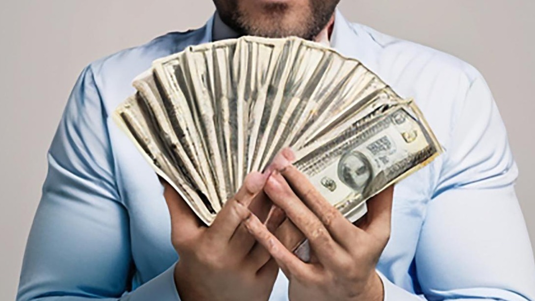 A man with a lot of money in his hands