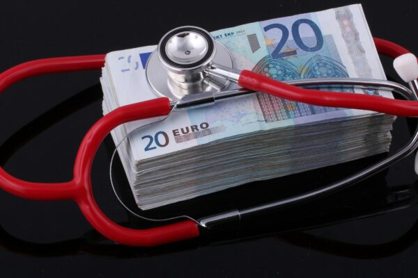 a stethoscope on top of a pile of euro bills
