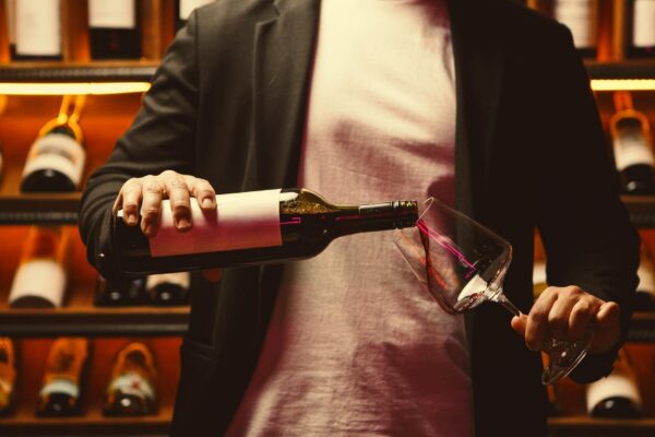 Man in Cellar Pouring Red Wine Carefully