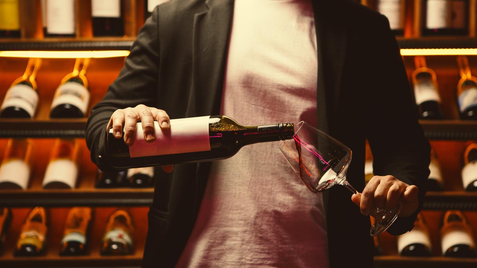 Man in Cellar Pouring Red Wine Carefully