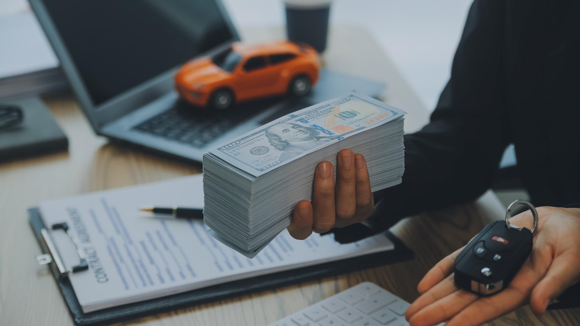 Salesman send key to customer after good deal agreement successful car loan contract buying or selling new vehicle