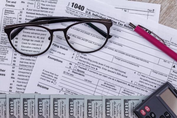 Income tax with instruction money calculator and glasses tax payment and filing concept