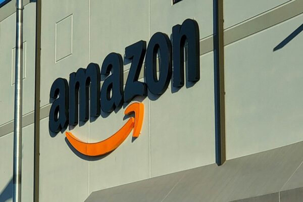an amazon store with a person sitting in front of it