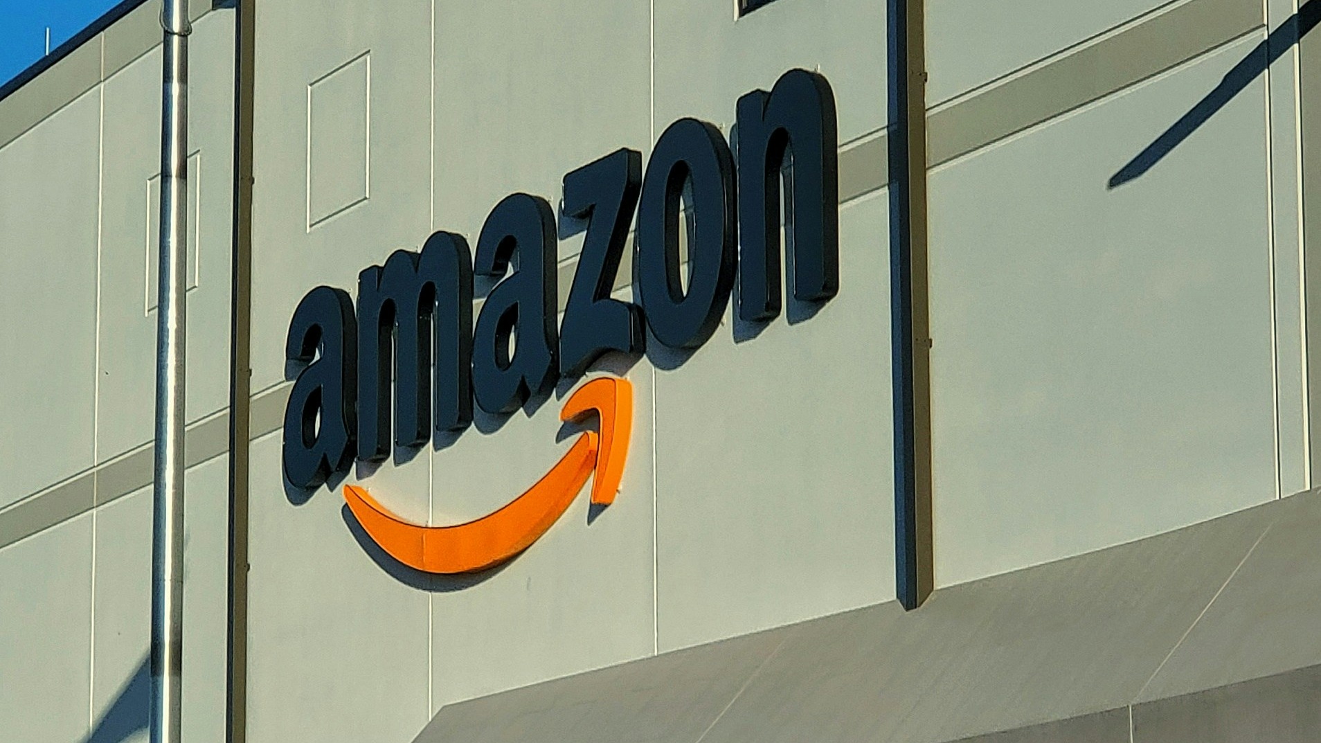 an amazon store with a person sitting in front of it