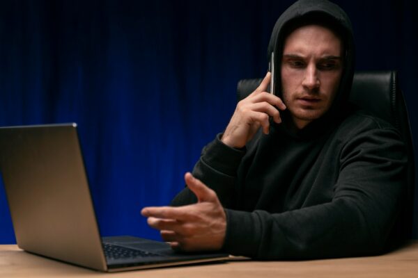 Medium shot programmer talking on phone