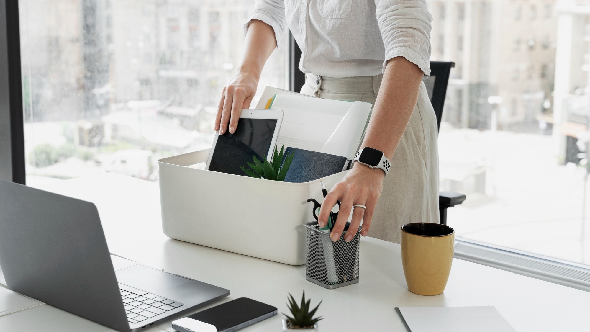 Side view woman packing desk items
