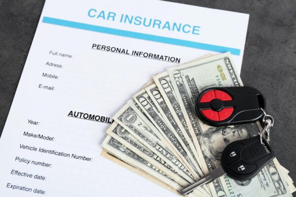 Car insurance form and money on table