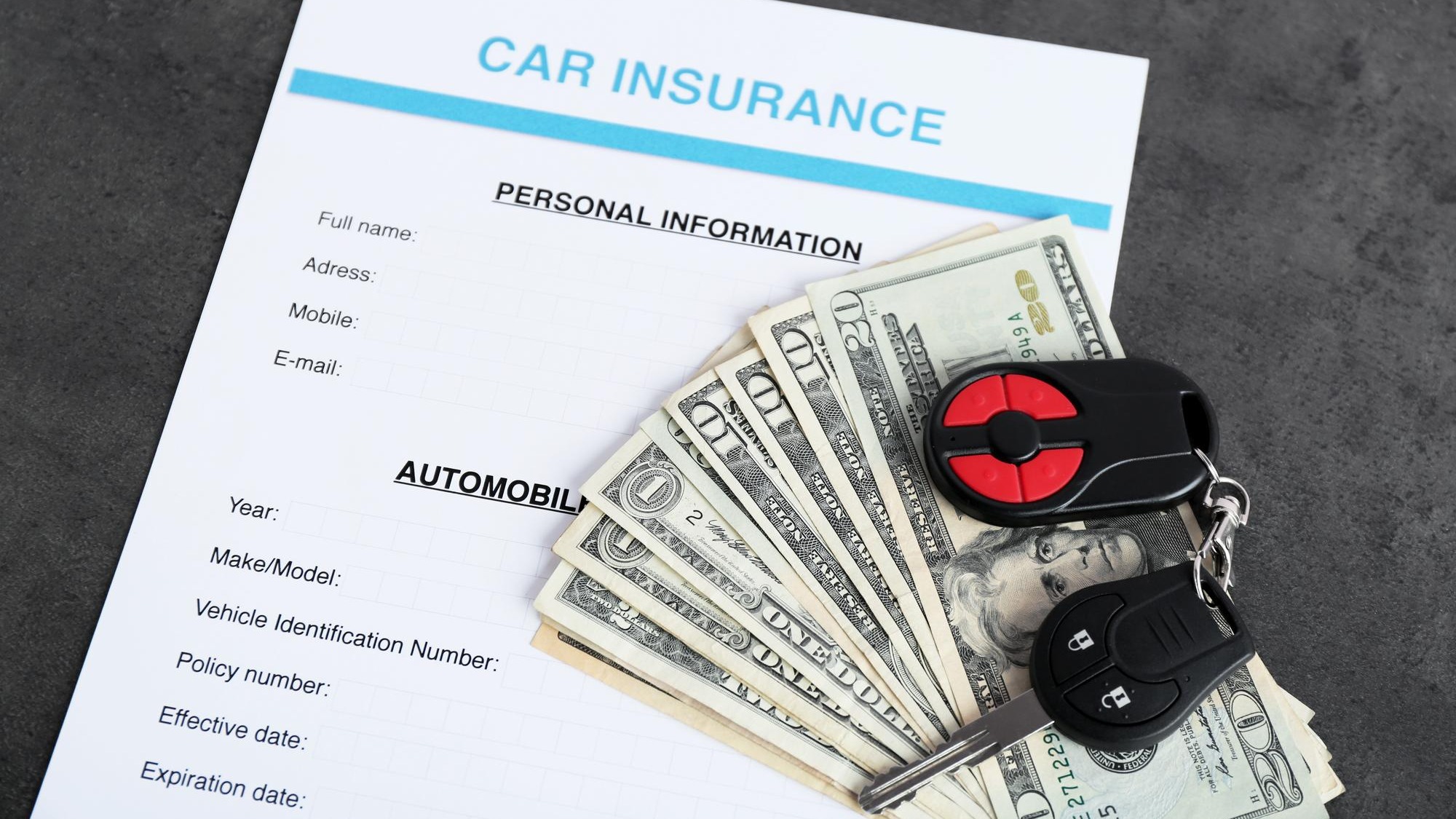 Car insurance form and money on table