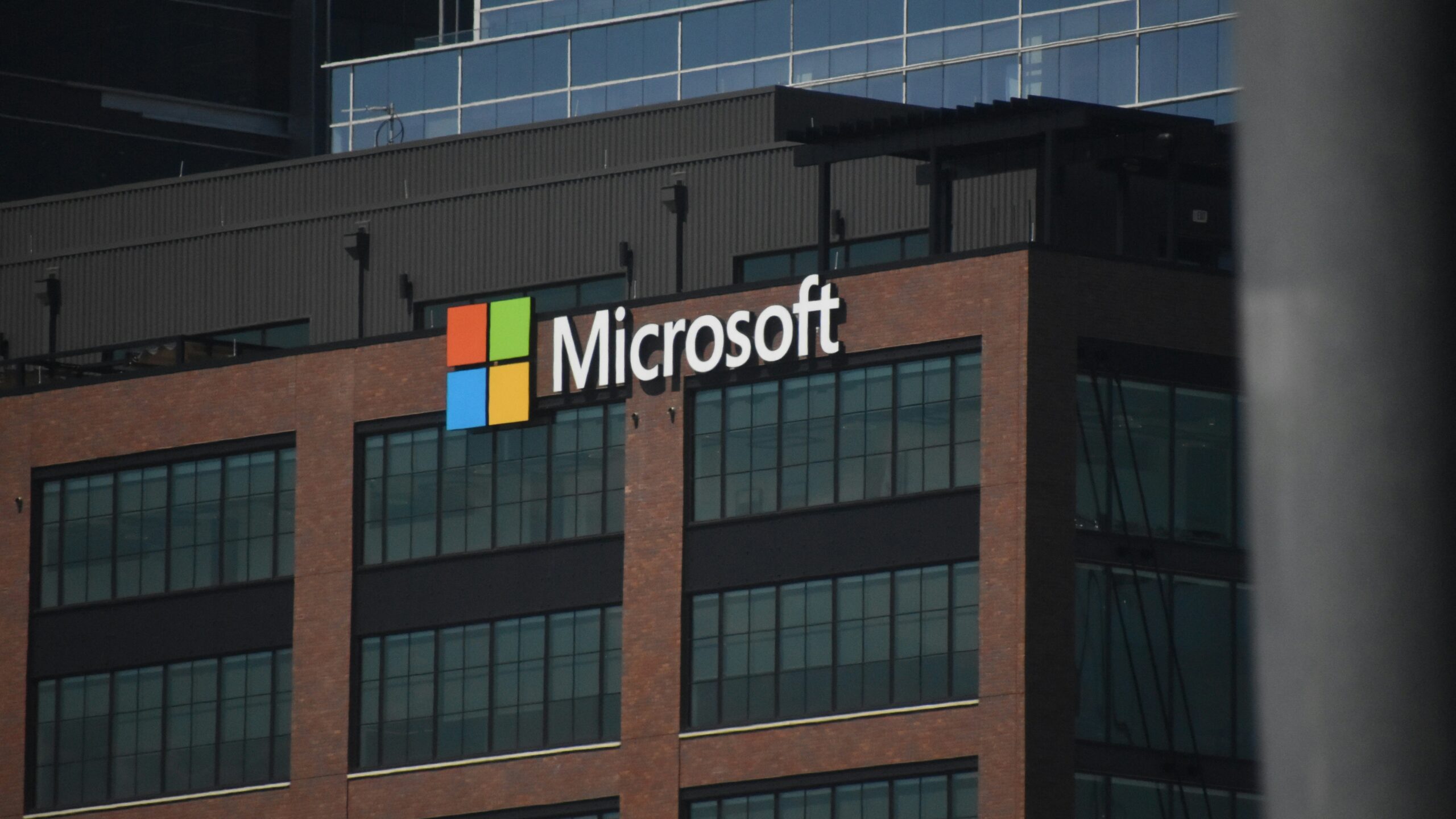A tall building with a microsoft logo on top of it