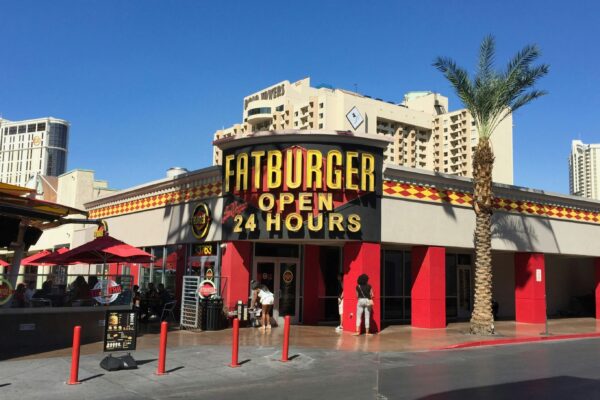 a restaurant with a sign that says fatburger open 4 hours
