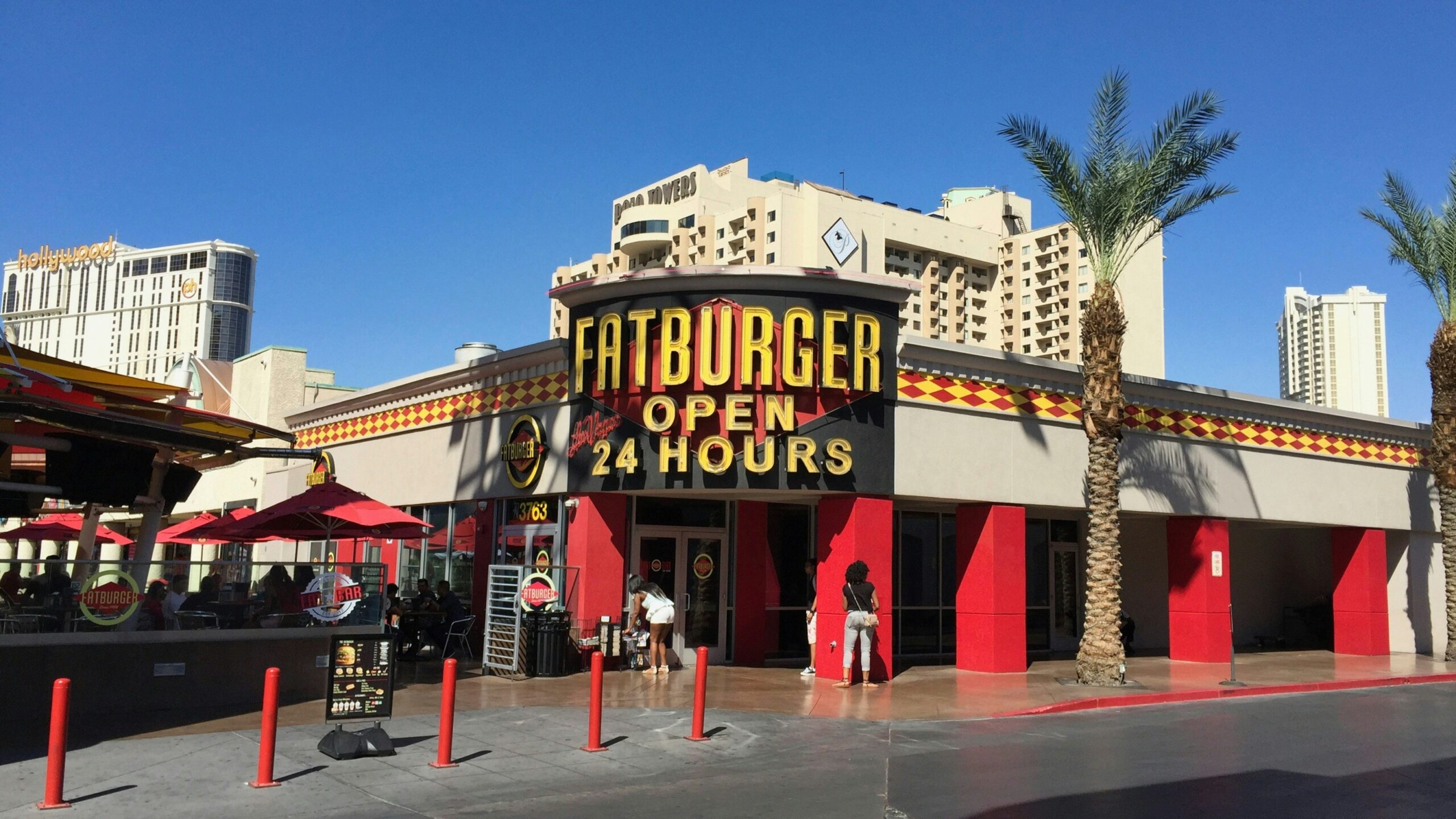 a restaurant with a sign that says fatburger open 4 hours