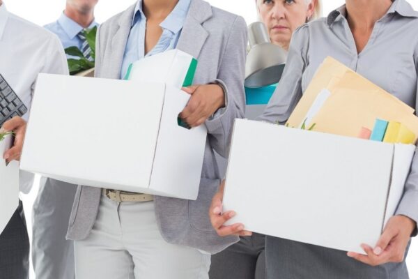 Employees carrying boxes after job loss