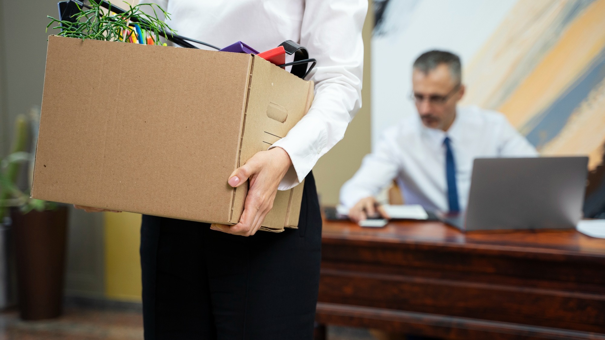 Woman carrying cardboard box side view