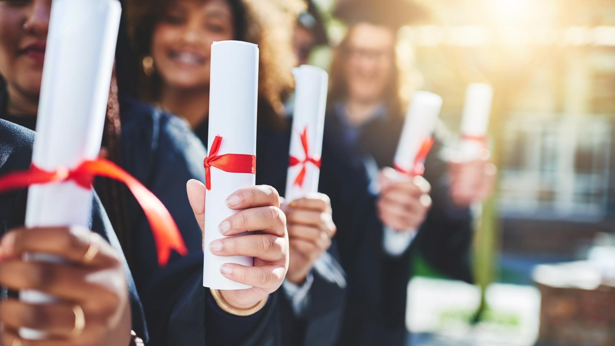 Graduation hands and students with certificate at college with education opportunity or achievement University friends and group of people at campus event with knowledge scholarship and diploma