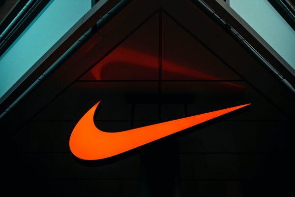 the nike logo is lit up on the side of a building