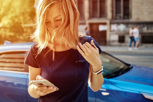 Woman using smartphone at city street