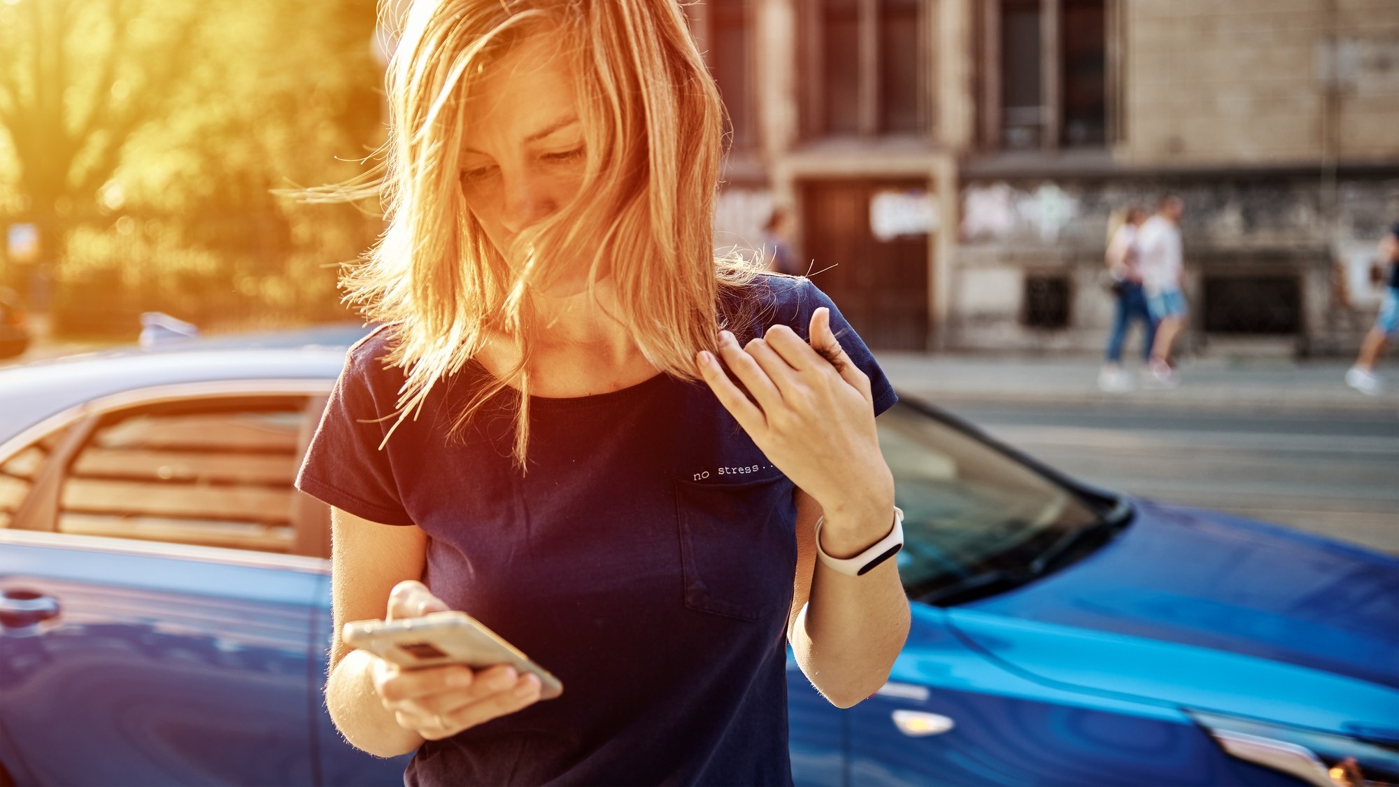 Woman using smartphone at city street