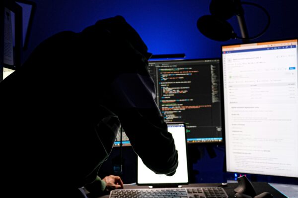 a man sitting in front of a computer monitor