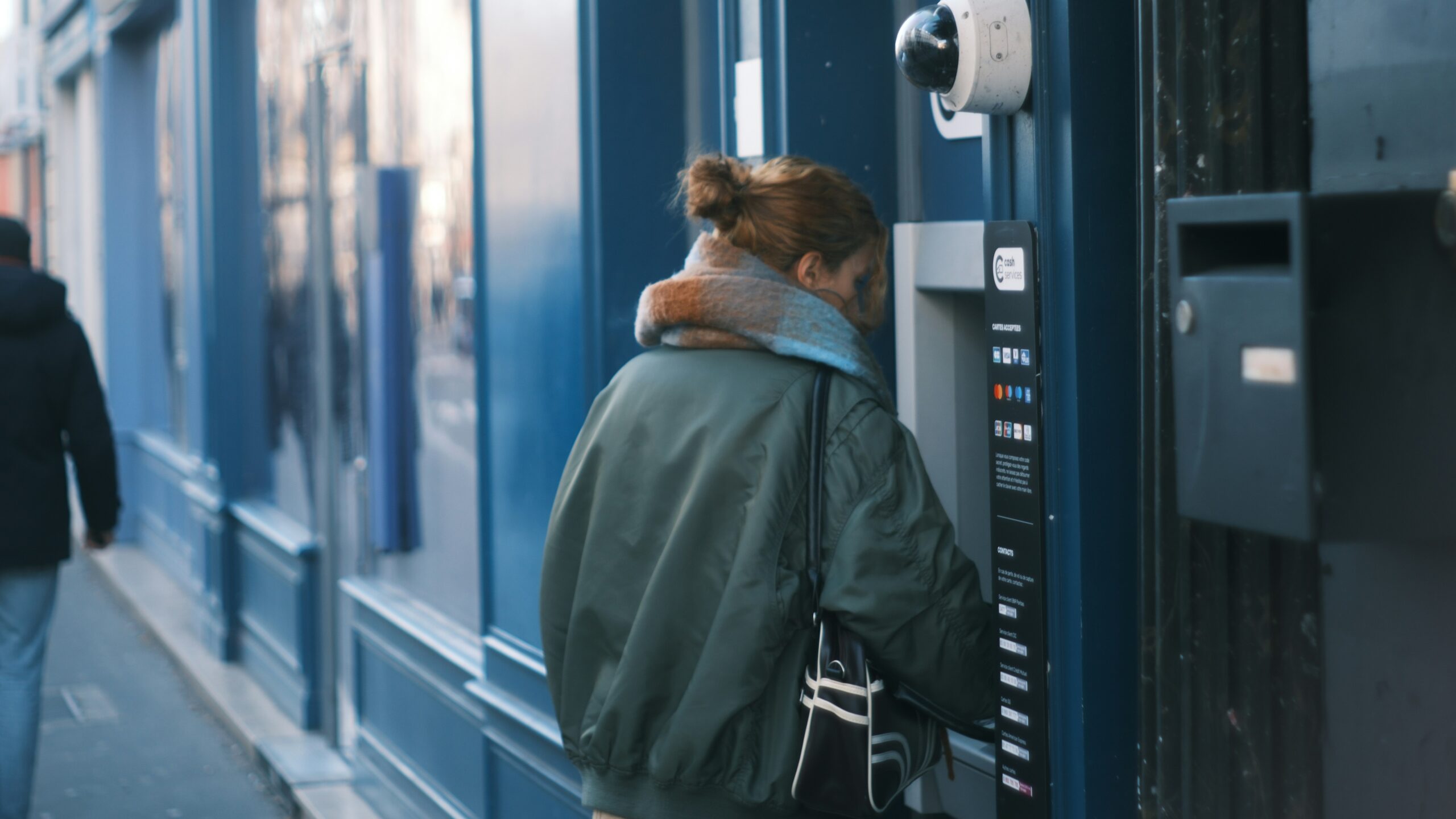 Woman using an atm on a city street