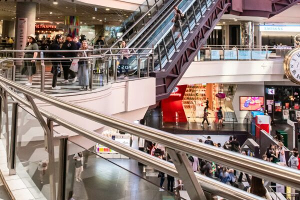 people walking inside building with escalator