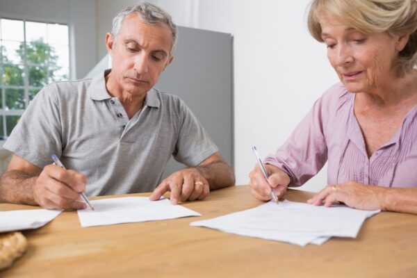 Couple signing documents together