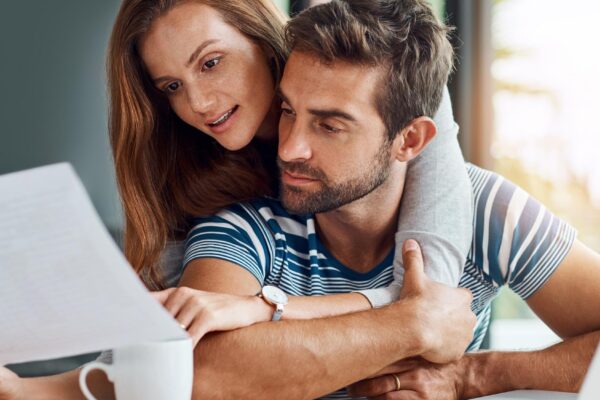 Couple people and reading documents with laptop for tax expenses and debt with interest rate Home relationship and explain for budget or saving plan for house finance mortgage and bills