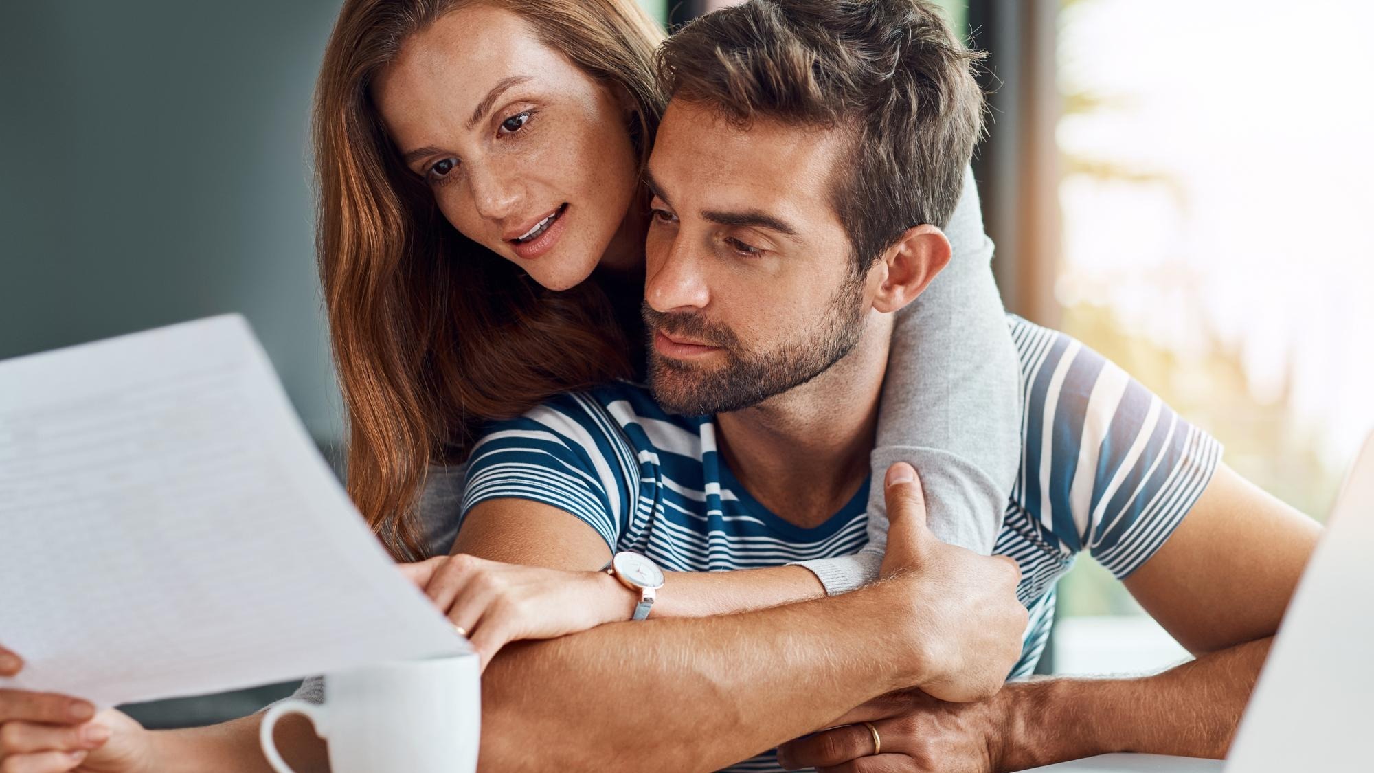 Couple people and reading documents with laptop for tax expenses and debt with interest rate Home relationship and explain for budget or saving plan for house finance mortgage and bills