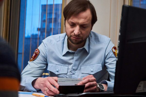 woman in blue button up shirt sitting at the table