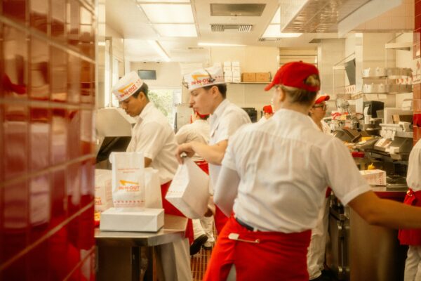 Restaurant workers preparing food in a busy kitchen.