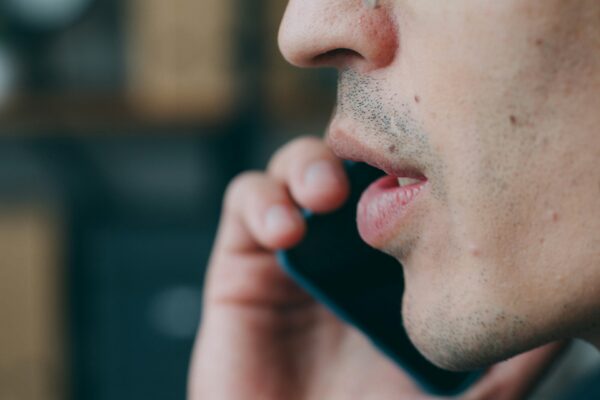 A close up of a person talking on a cell phone