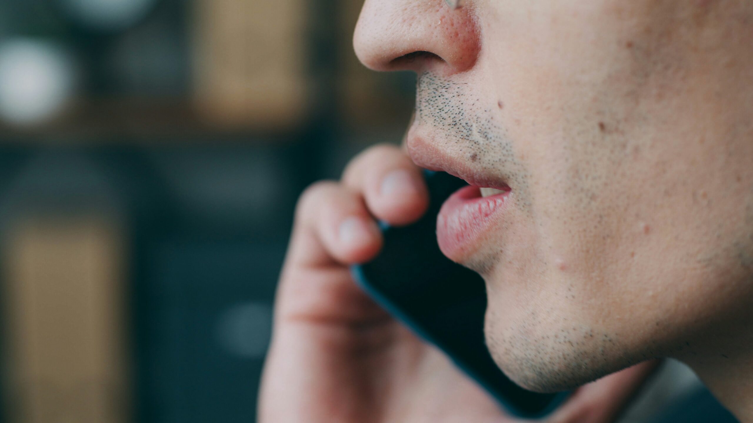 A close up of a person talking on a cell phone