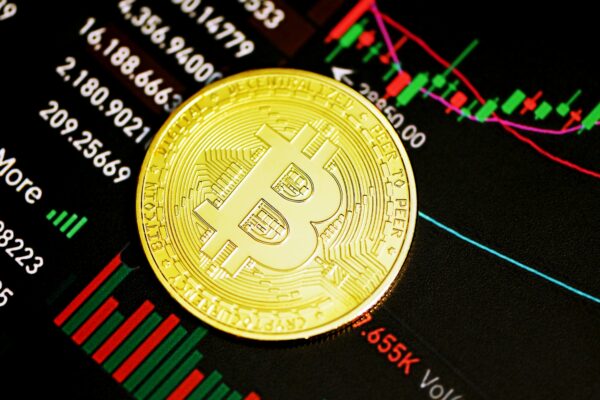 gold round coin on black surface