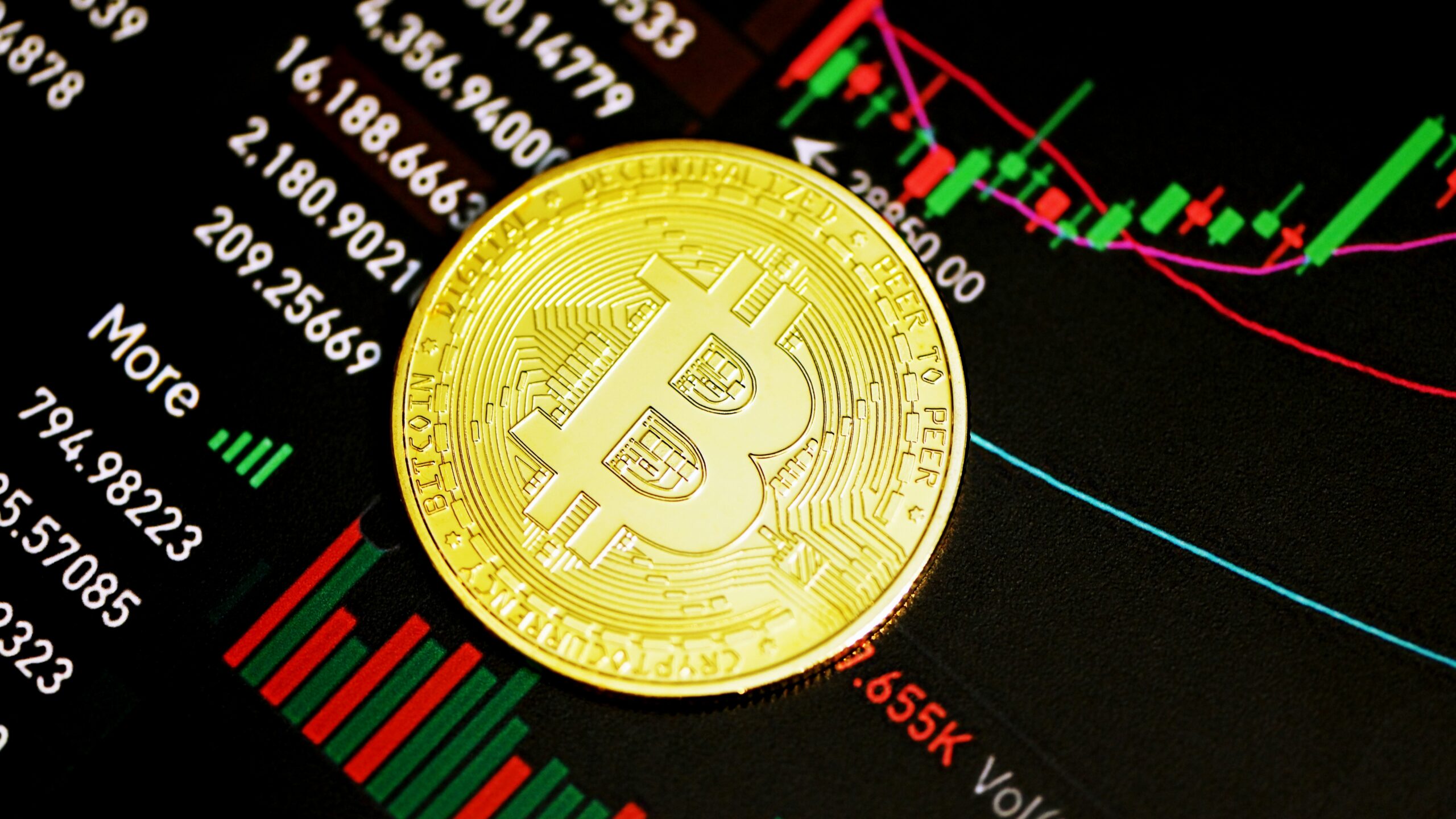 gold round coin on black surface