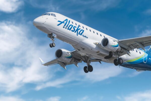 white and blue passenger plane under blue sky during daytime