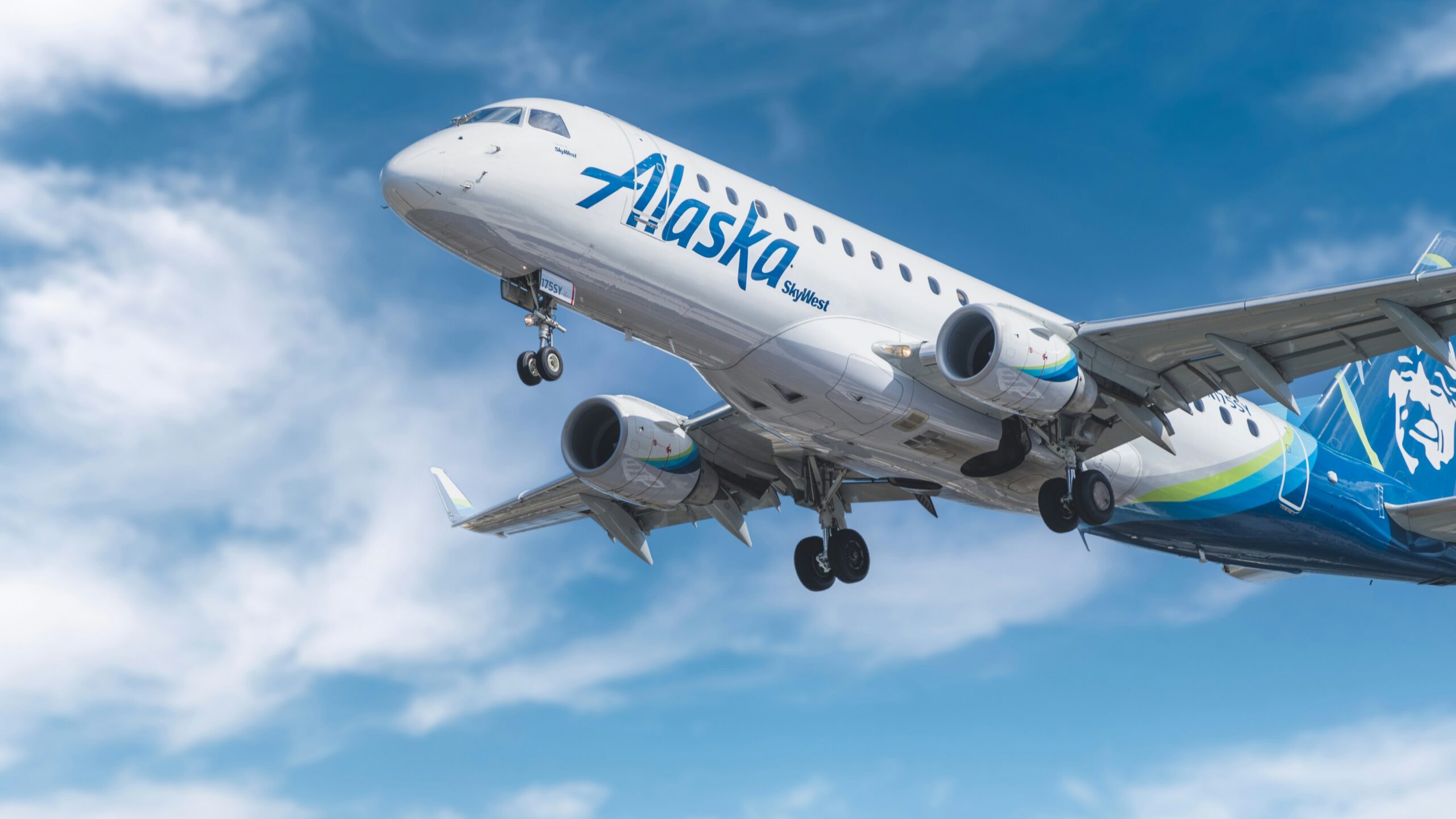 white and blue passenger plane under blue sky during daytime